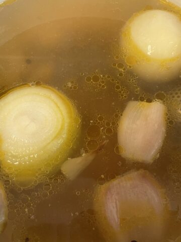 A golden color chicken broth.