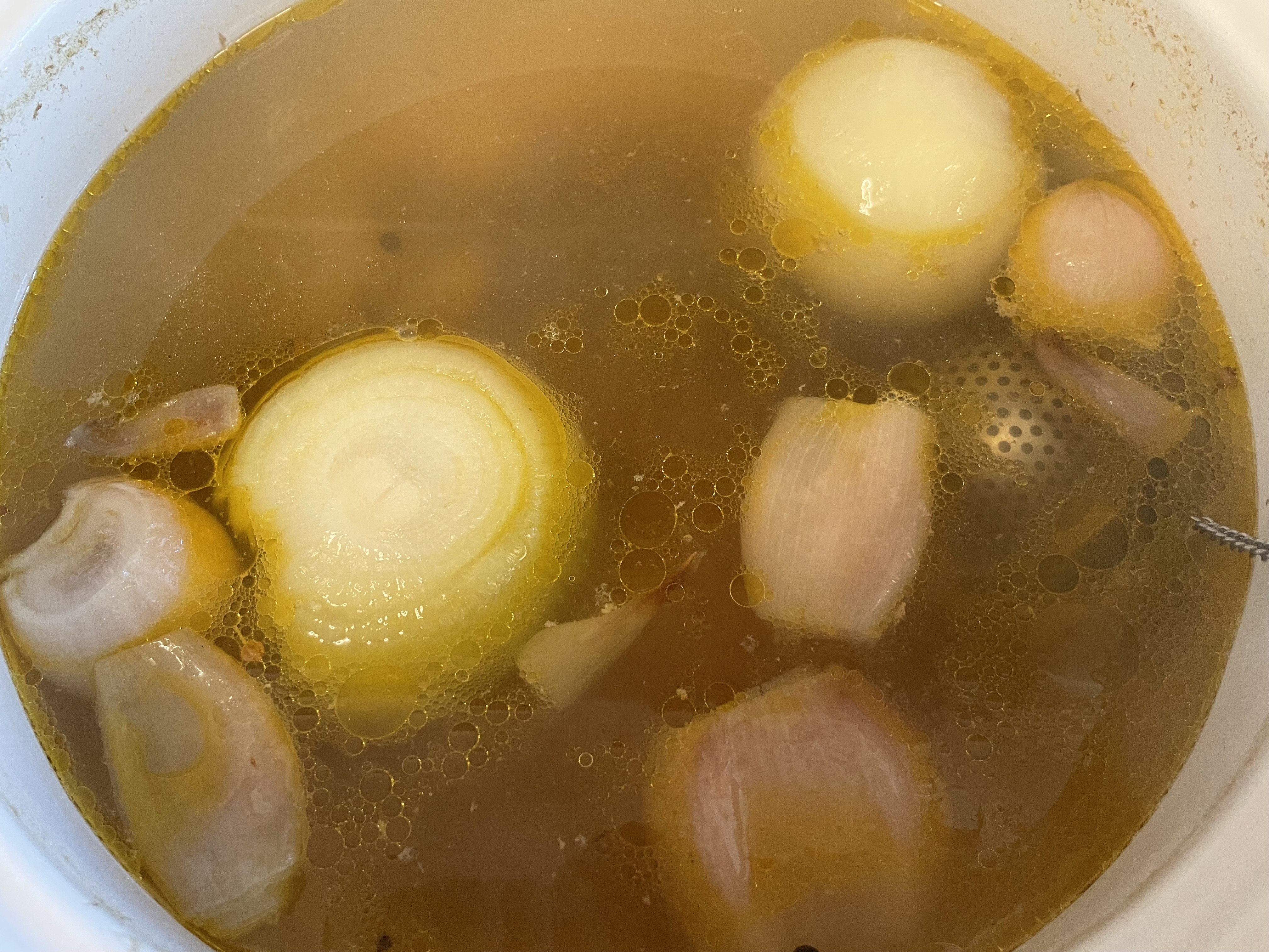 A golden color chicken broth.